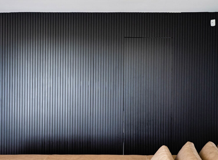 Custom slat, panel accent wall finished in matte black paint