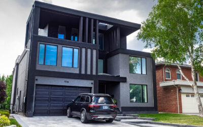 New home custom construction featuring a contemporary design of grey and black stucco, and custom exterior LED lighting