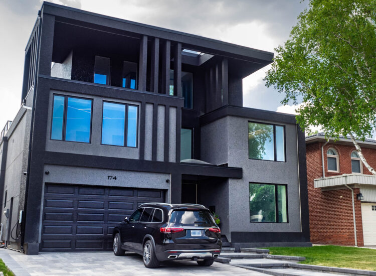 New home custom construction featuring a contemporary design of grey and black stucco, and custom exterior LED lighting