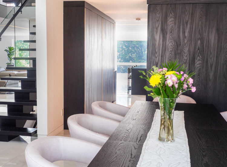 Custom construction of dining area with custom wood finish walls