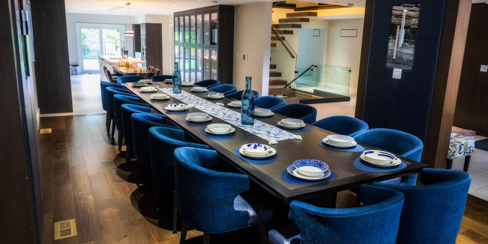 Large dining area with 18 seat dining table, hardwood floors, and blue accents