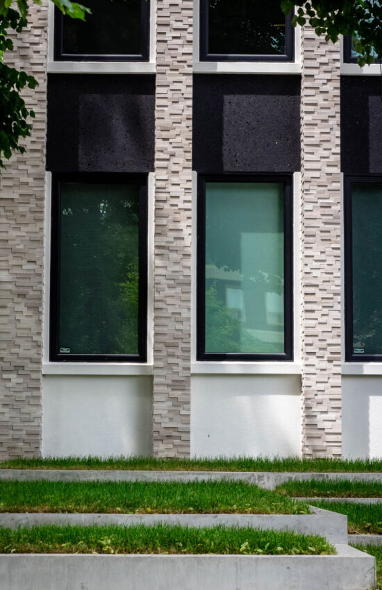 Custom stone facade on front of house with stucco accented areas