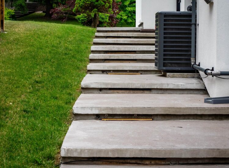 Heated cement staircase on the side of house connecting the front and back yards