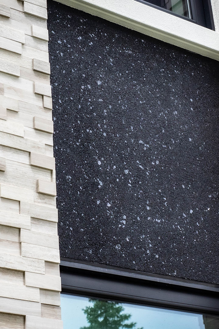 Custom stone facade on front of house with stucco accented areas