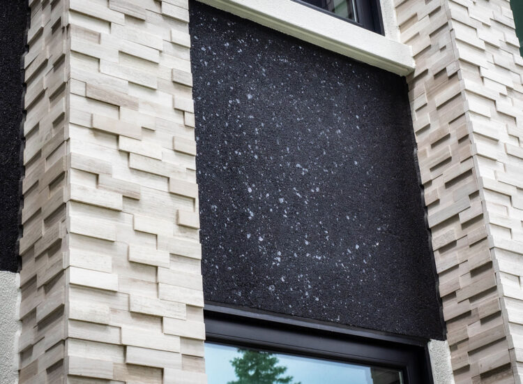 Custom stone facade on front of house with stucco accented areas